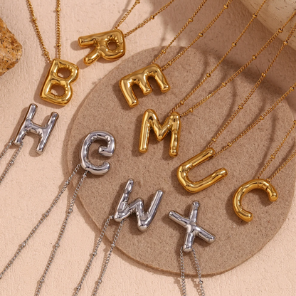 bubble initial necklace flat lay