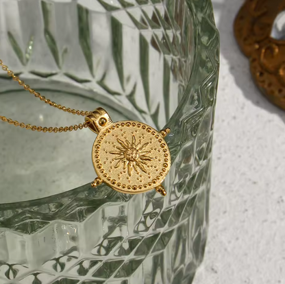 embossed sun necklace flat lay image