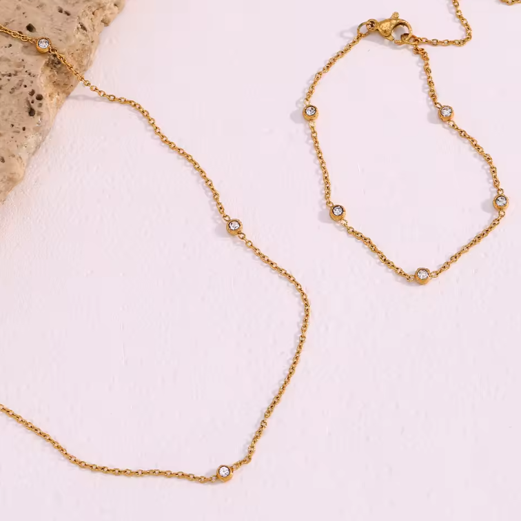 gem charm necklace and bracelet flatlay