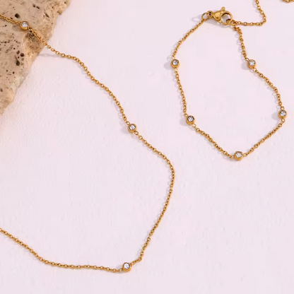 gem charm necklace and bracelet flatlay