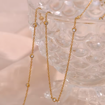 gem charm necklace flat lay