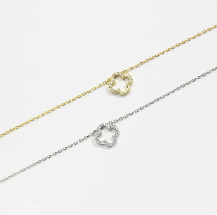 hollow clover necklace flat lay